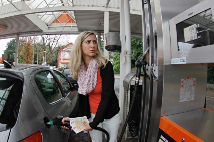 Žena tankuje u benzinové pumpy.