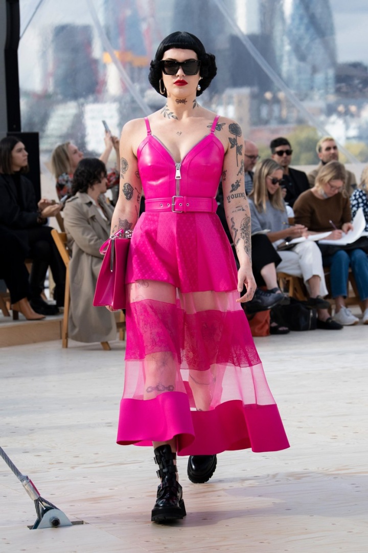 Modelka v transparentně růžových šatech.