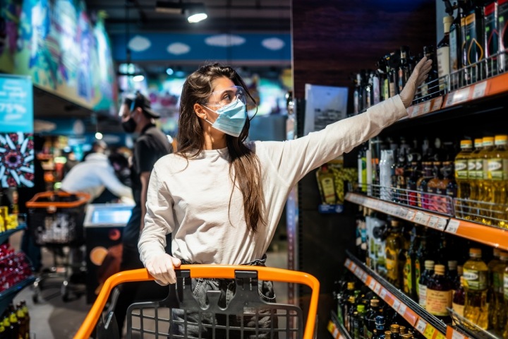 Žena s rouškou nakupuje v supermarketu Žena s rouškou nakupuje v supermarketu