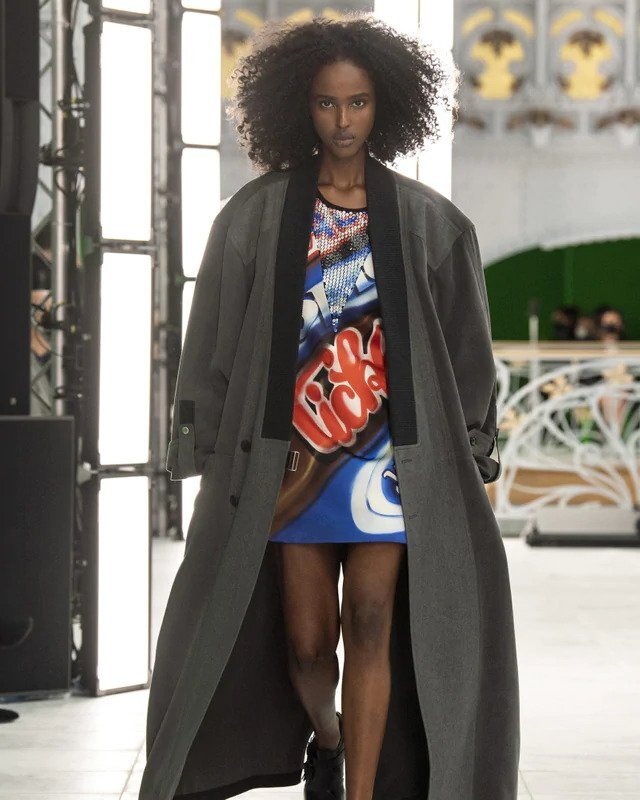 Žena v trenčkotu a barevných šatech Louis Vuitton SS2021