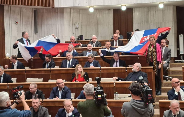 Zástupci Smer-SD vytáhli dvě vlajky Slovenské republiky a rozprostřeli je v plénu přes sebe.